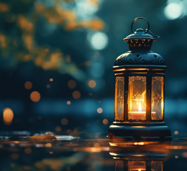 Vintage lantern illuminates, its light dancing across the reflec